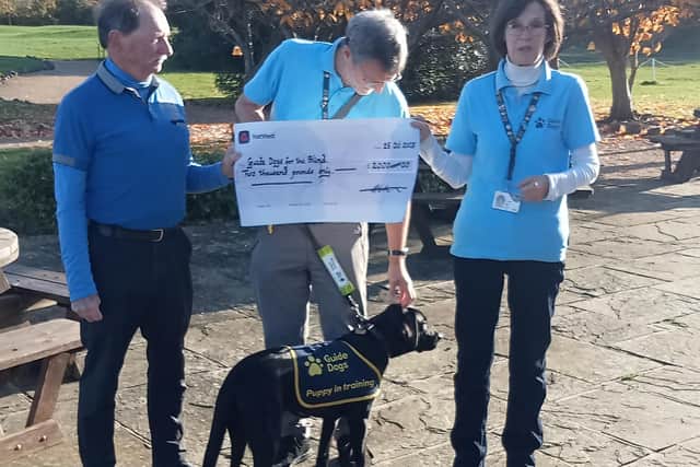 Martin Powell-Jones presenting the cheque for £2,000. The dog is Ffion with Tim and Sarah Shaw from Guide Dogs for the Blind charity | Picture courtesy of Chichester GC veterans