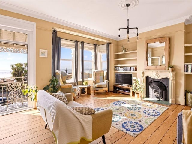 The living room on the first floor is a highlight, offering stunning direct sea views