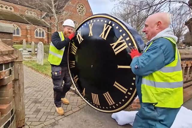 Renovated clock faces being reinstalled on the spire at St John's Church, Burgess Hill