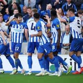 Kaoru Mitoma of Brighton & Hove Albion celebrates with teammates after scoring the team's second goal against Bournemouth in the Premier League