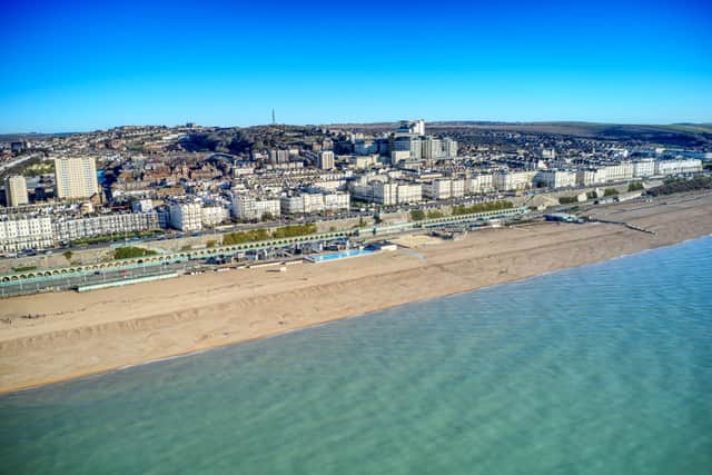 Aerial view of Brighton seafront with Victorian buildings along Marine Drive and Madeira Drive with the Volks Electric Railway in the foreground
