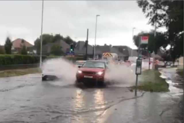 Traffic moving through floodwater in Rectory Road in August 2018