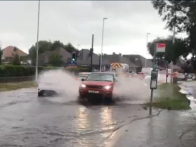 Traffic moving through floodwater in Rectory Road in August 2018