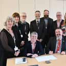 QVH's Chair of the Board, Chief Executive Officer and Board of Directors signing the charter.