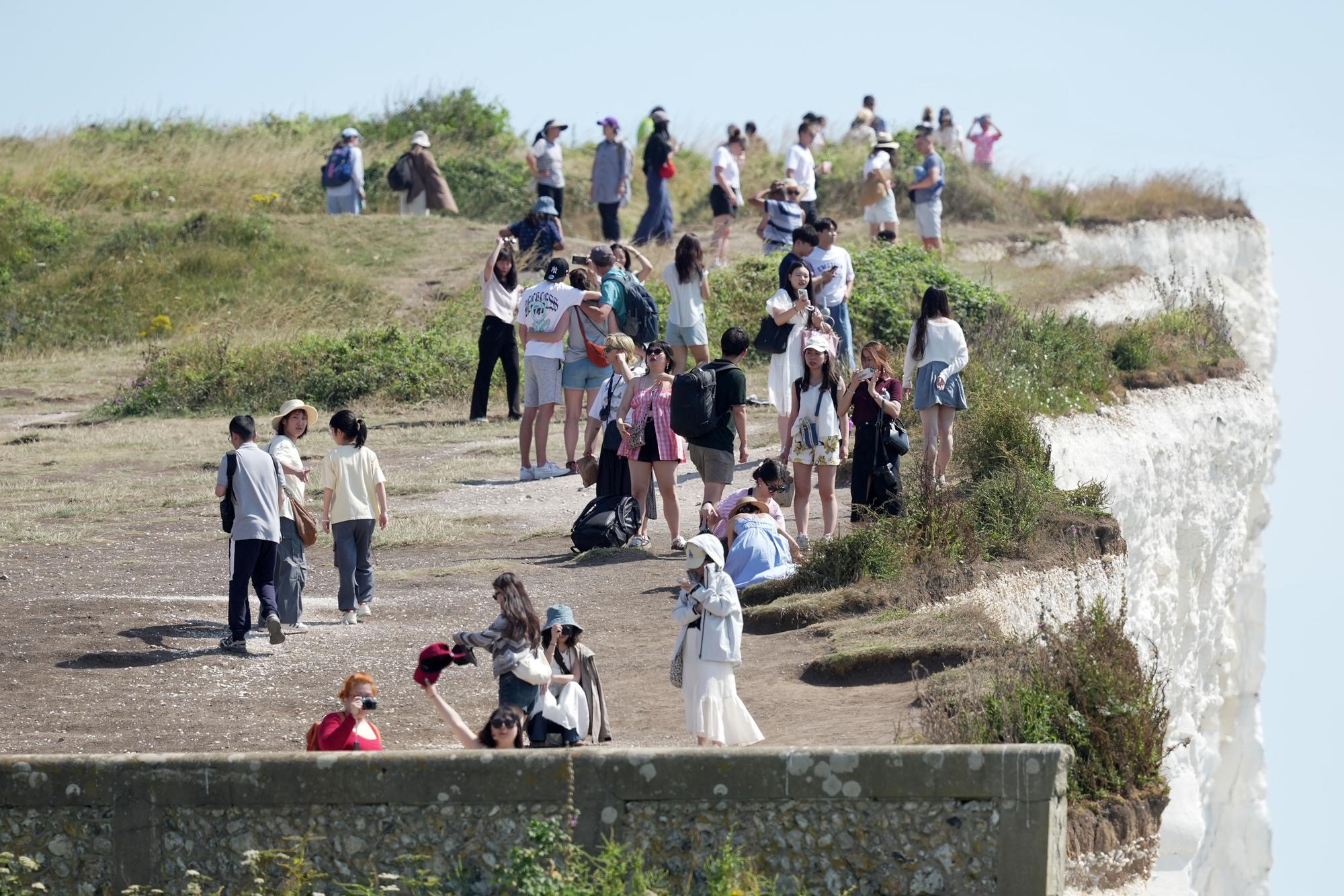 Shocking photos show sunbaskers standing near edge of cliffs at Birling Gap
