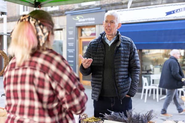 John Milne speaking with a local stall holder in Horsham's Carfax Market