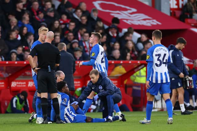 NOTTINGHAM, ENGLAND - NOVEMBER 25: Tariq Lamptey of Brighton & Hove Albion receives medical treatment during the Premier League match between Nottingham Forest and Brighton & Hove Albion at City Ground on November 25, 2023 in Nottingham, England. (Photo by Marc Atkins/Getty Images)