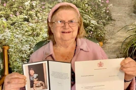 Beryl, a resident of Haviland House, was delighted to be chosen to be pictured with the letter and card from the King