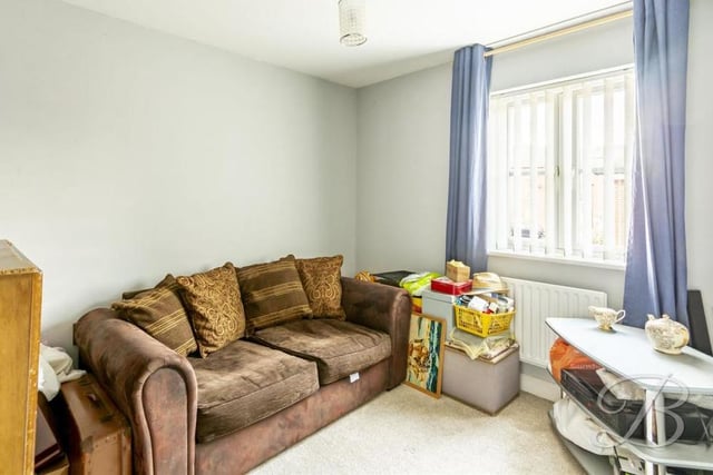 The third bedroom is a versatile space that can be used as an additional living area, if you wish. It has a carpeted floor, a central heating radiator and a window facing the back of the house.