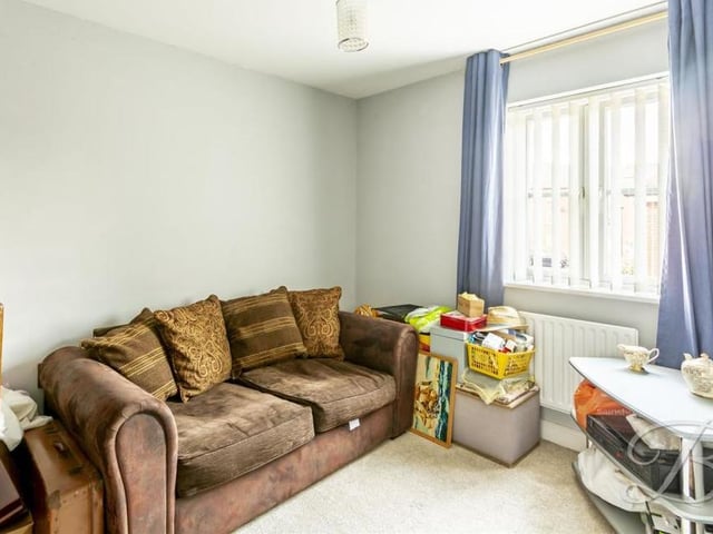 The third bedroom is a versatile space that can be used as an additional living area, if you wish. It has a carpeted floor, a central heating radiator and a window facing the back of the house.