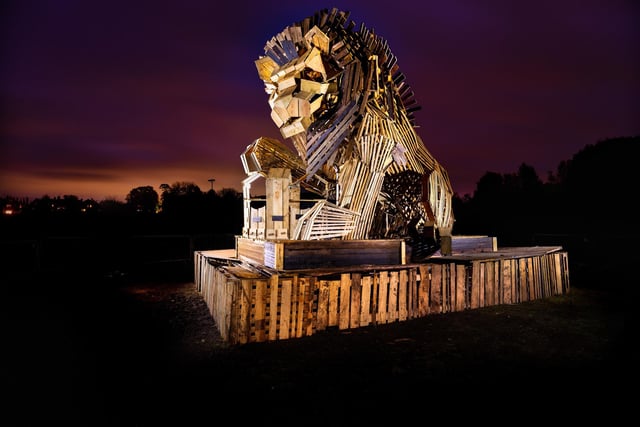 Members of the carnival society carried blazing fire banners in a series of torchlit processions to the bonfire sculpture which this year depicted a lion with its paw placed on a crown to commemorate the Queen.