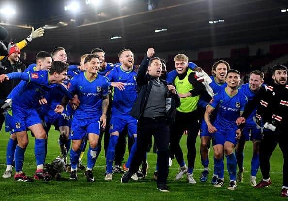 Paul Hurst, Manager of Grimsby Town celebrates victory with his players at full time at Southampton
