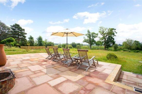 There is a paved terrace adjoining the southern side of the house with views to the South Downs