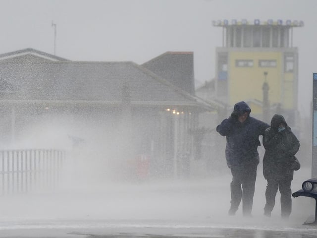 People brave the weather as they make their way along the seafront in Southsea as Storm Barra hit. Picture: Andrew Matthews/PA Wire
