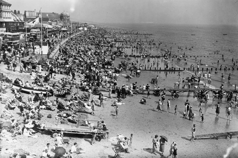 7th August 1933:  A view from the pier at Bognor Regis during a heatwave showing the crowded beach .