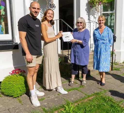 Sara Bowers, owner of The Steyning Bookshop, receiving her third prize from judges Finn Bigg and Gemma Thompson, watched by Rebecca Louis from Steyning & District Business Chamber