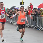Adam Clarke and Charlie Brisley decide to cross the line together in the Hastings Half Marathon 2023 | Picture: Justin Lycett