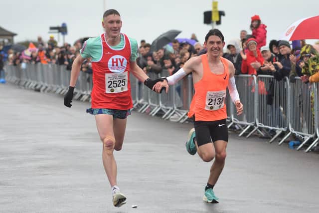 Adam Clarke and Charlie Brisley decide to cross the line together in the Hastings Half Marathon 2023 | Picture: Justin Lycett