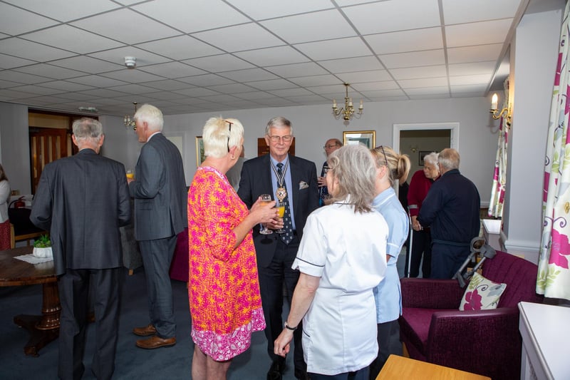 The Master, Brigadier John Meardon DL, chatting with guests at Rustington Convalescent Home before the celebration lunch