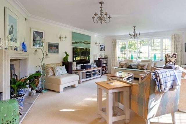 The property has an elegant formal sitting room which is sun-filled with large windows and French doors opening to the garden.