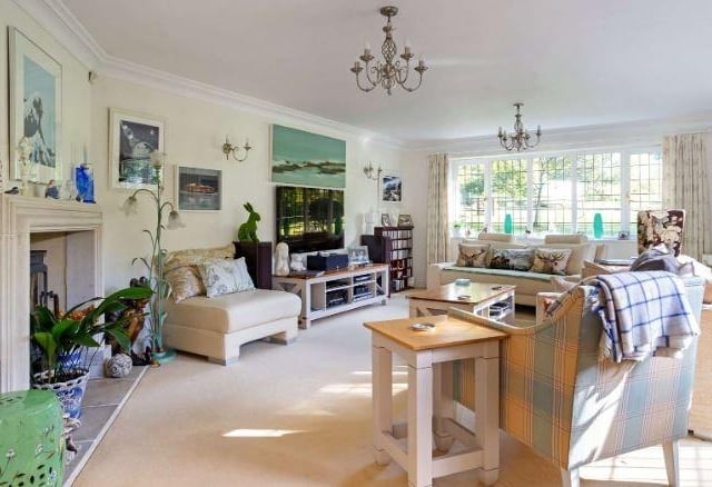 The property has an elegant formal sitting room which is sun-filled with large windows and French doors opening to the garden.