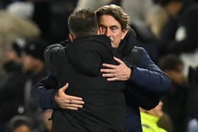 Brentford's Danish head coach Thomas Frank (R) and Brighton's Italian head coach Roberto De Zerbi (L) embrace at the Amex Stadium last December