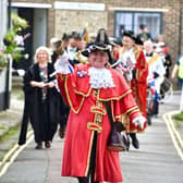 Arundel's Town Crier leads the Coronation Community Procession through the streets of Arundel