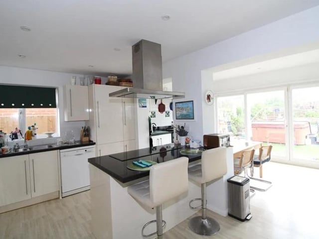 The kitchen features an aga cooker, electric oven and island.