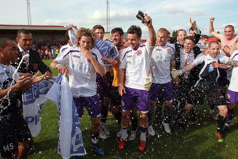 Sergio Torres and Matt Tubbs of Crawley Town celebrate with team mates at the final whistle after a win that secures promotion during the Blue Square Bet Premier League match between Tamworth and Crawley Town at The Lamb Ground on April 9, 2011.