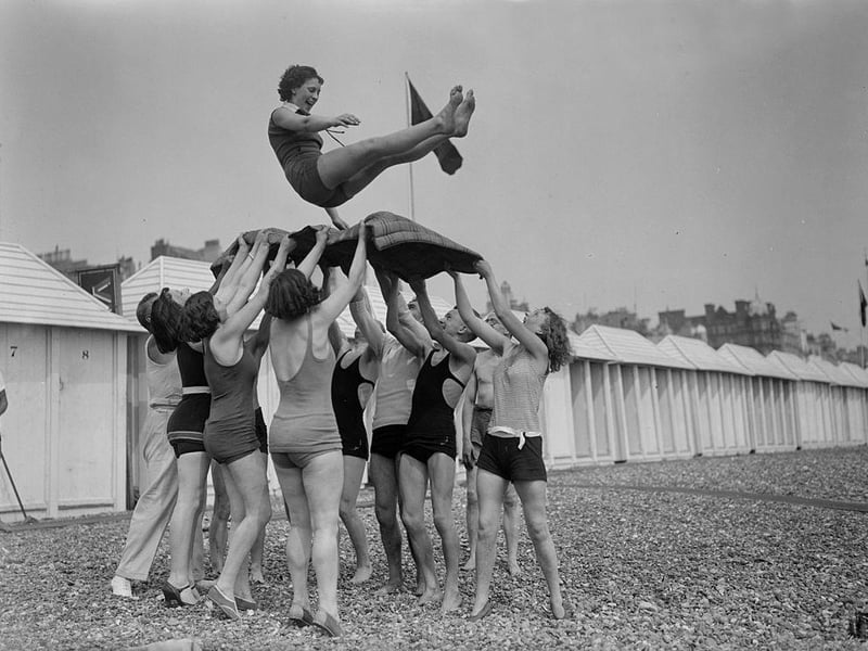 Day trippers give the bumps to the birthday girl at Brighton seaside resort on 5th June 1930.