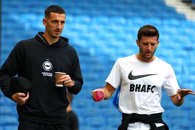Brighton and Hove Albion midfielder Adam Lallana (r) sustained a calf injury during the Premier League win against West Ham last month