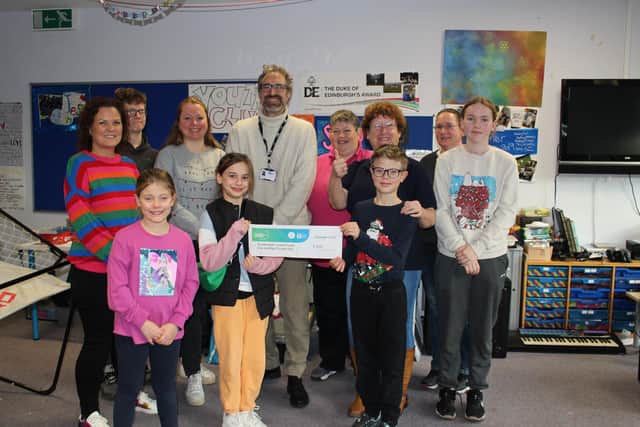 Councillor Sam Raby presents £500 cheque to Southwater Youth Project trustees, youth workers and young people. Picture contributed