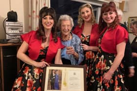 Jose Allen celebrates her 100th birthday at her home in Henfield with members of The Candy Girls - and her framed birthday card from King Charles and Queen Camilla
