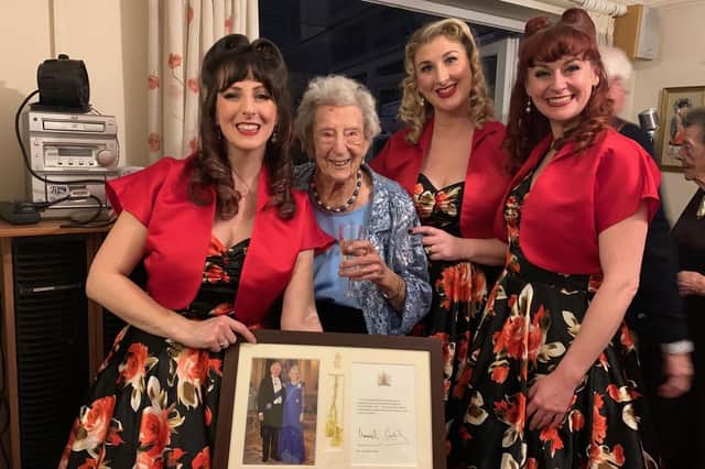 Jose Allen celebrates her 100th birthday at her home in Henfield with members of The Candy Girls - and her framed birthday card from King Charles and Queen Camilla