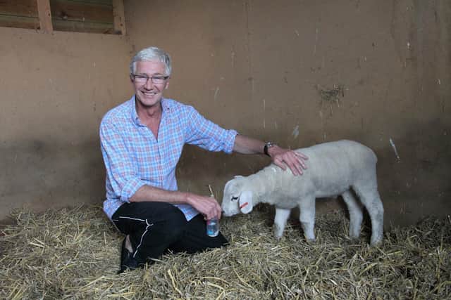 Portrait of Paul O Grady and Winston the lamb in his new home. Photo: Joe Murphy/RSPCA