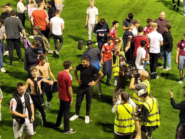 Crawley Town fans on the pitch at the end of the game