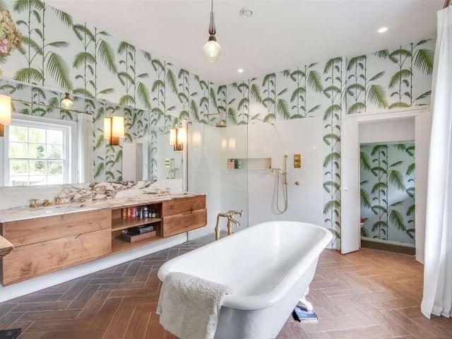 The principal en suite bathroom includes a roll top bath, large walk-in rain shower, twin basins and a separate WC