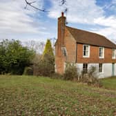 A farmhouse with farm buildings set within 119 acres on the edge of the Ashdown Forest is on the market