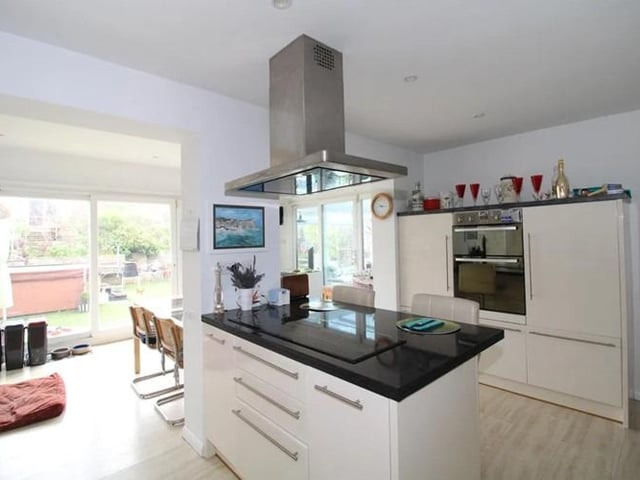 The kitchen features an aga cooker, electric oven and island.