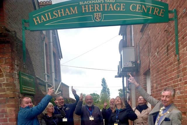 Museum custodians and town councillors standing under the newly installed heritage centre sign