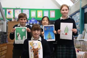 Children with their winning entries in the festive card design competition at Highfield and Brookham