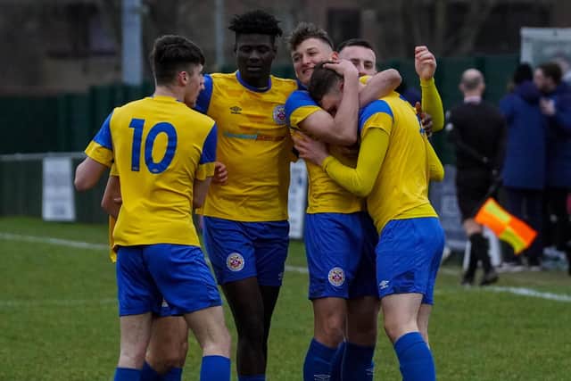 Leon Greig is congratulated by his teammates after scoring the opening goal for Eastbourne Town against Saltdean | Picture: David Tungate