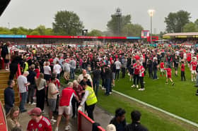 Crawley Town fans celebrate after the game