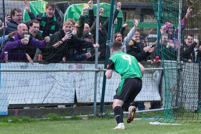 Dan Perry runs off to celebrate his late goal - and winning goal - with the fans as Burgess Hill edge home past Three Bridges | Picture: Chris Neal