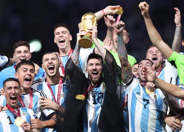 Lionel Messi lifts the FIFA World Cup trophy following Argentina's dramatic penalty shootout win over France in Sunday's final