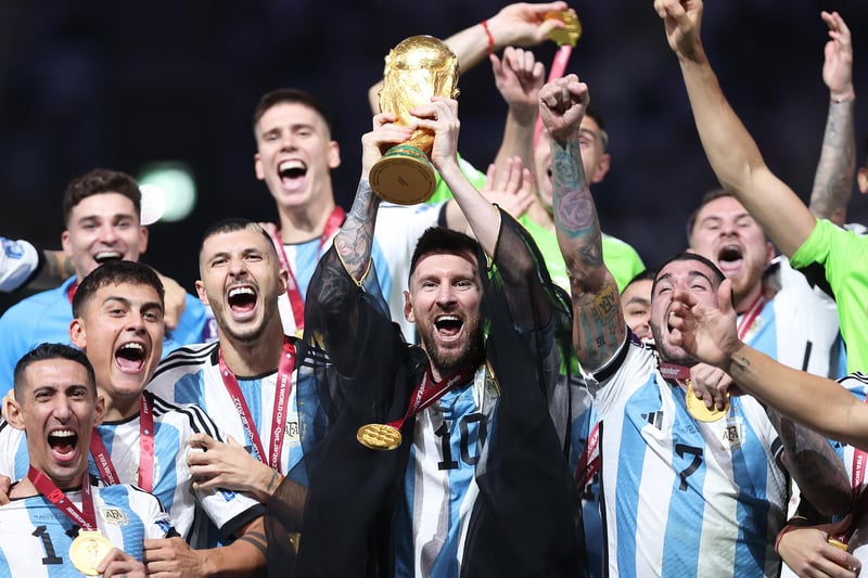 Lionel Messi lifts the FIFA World Cup trophy following Argentina's dramatic penalty shootout win over France in Sunday's final