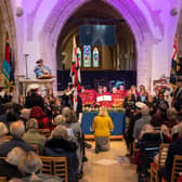 Choir of schoolchildren aged ten from Homefield Primary School, conducted by music teacher Claire Cossins, with Royal British Legion band Lancing Brass, seated centre, as Worthing town crier Bob Smytherman announces the names of the Brave 11, the victims of the Lalla Rookh disaster and their 48 dependants. Picture: Andrew Mardell