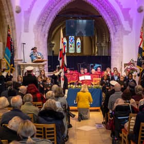 Choir of schoolchildren aged ten from Homefield Primary School, conducted by music teacher Claire Cossins, with Royal British Legion band Lancing Brass, seated centre, as Worthing town crier Bob Smytherman announces the names of the Brave 11, the victims of the Lalla Rookh disaster and their 48 dependants. Picture: Andrew Mardell