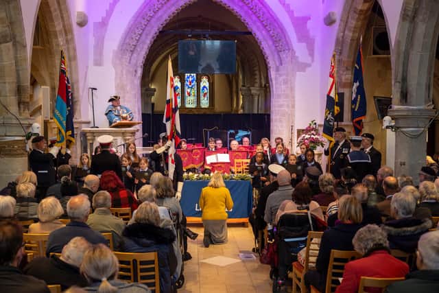 Choir of schoolchildren aged ten from Homefield Primary School, conducted by music teacher Claire Cossins, with Royal British Legion band Lancing Brass, seated centre, as Worthing town crier Bob Smytherman announces the names of the Brave 11, the victims of the Lalla Rookh disaster and their 48 dependants. Picture: Andrew Mardell