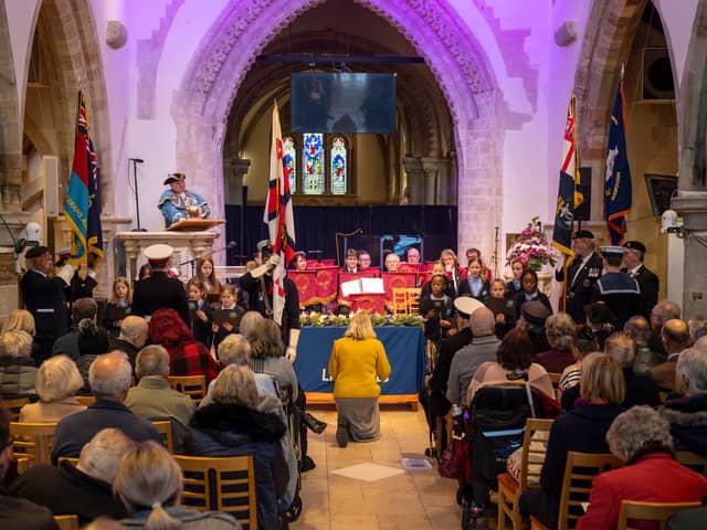 Choir of schoolchildren aged ten from Homefield Primary School, conducted by music teacher Claire Cossins, with Royal British Legion band Lancing Brass, seated centre, as Worthing town crier Bob Smytherman announces the names of the Brave 11, the victims of the Lalla Rookh disaster and their 48 dependants. Picture: Andrew Mardell